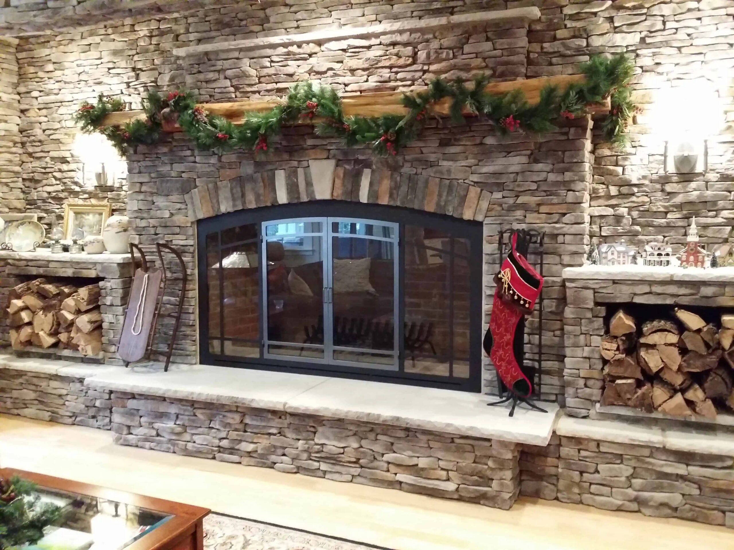custom glass doors on wood burning fireplace with surround and mantel